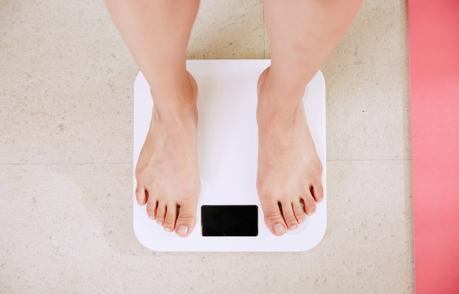 person standing on white digital bathroom scale