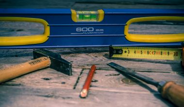 orange pen beside blue tape dispenser