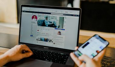 person using both laptop and smartphone