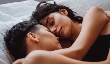 A loving couple sleeps peacefully, embracing each other closely with content expressions.