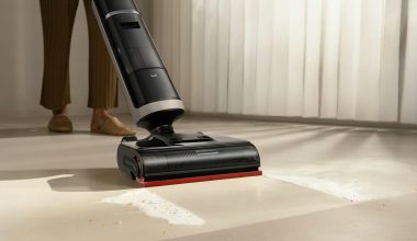 A person using a cordless vacuum cleaner on a floor
